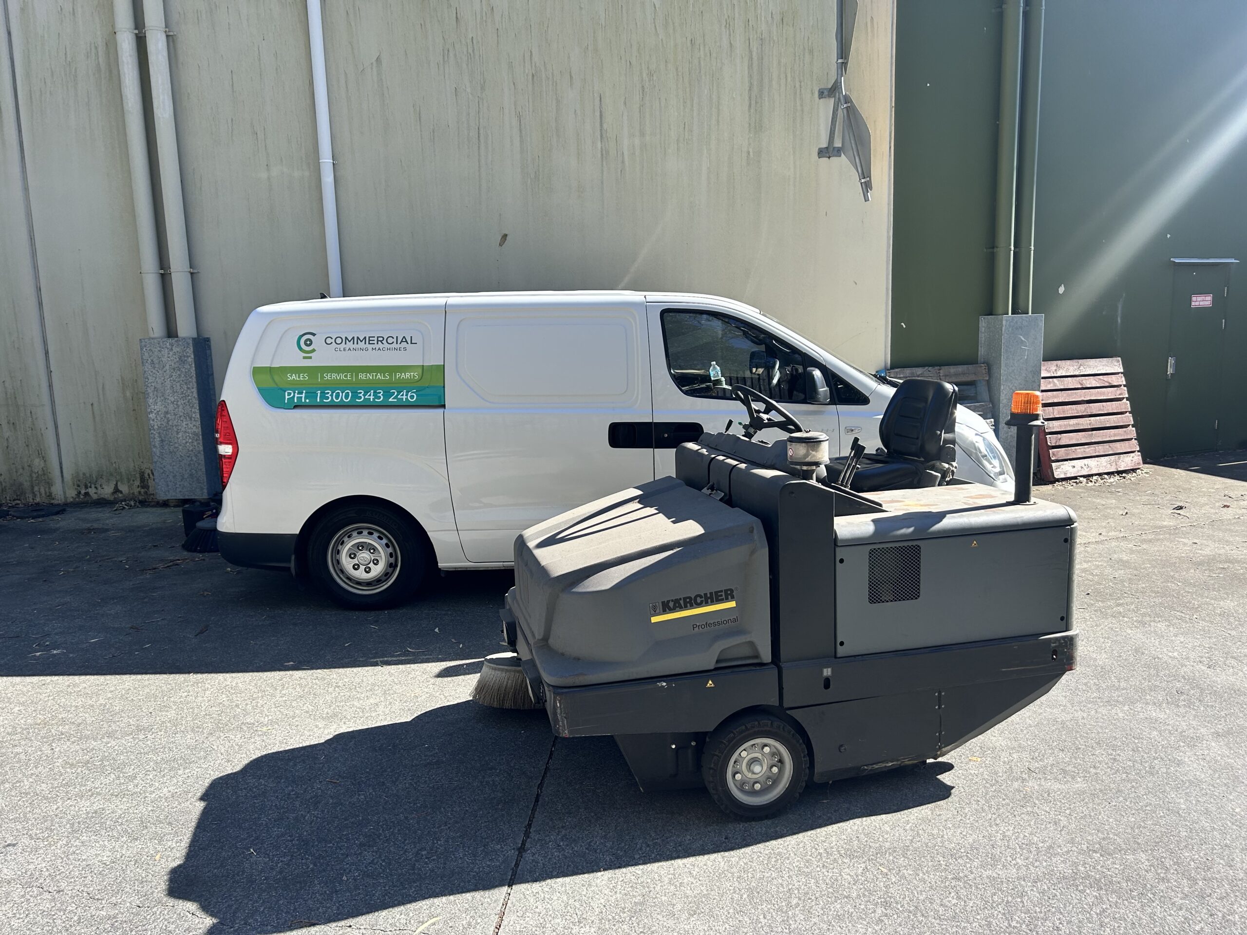 Commercial Cleaning Machines van with Karcher industrial floor sweeper during service in Brisbane