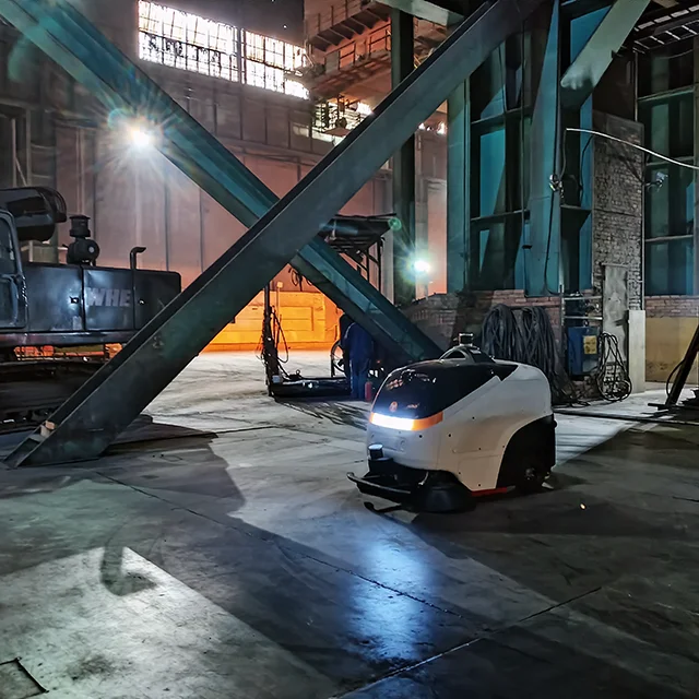 FloorBot Max 100 robotic floor cleaner operating in an industrial factory