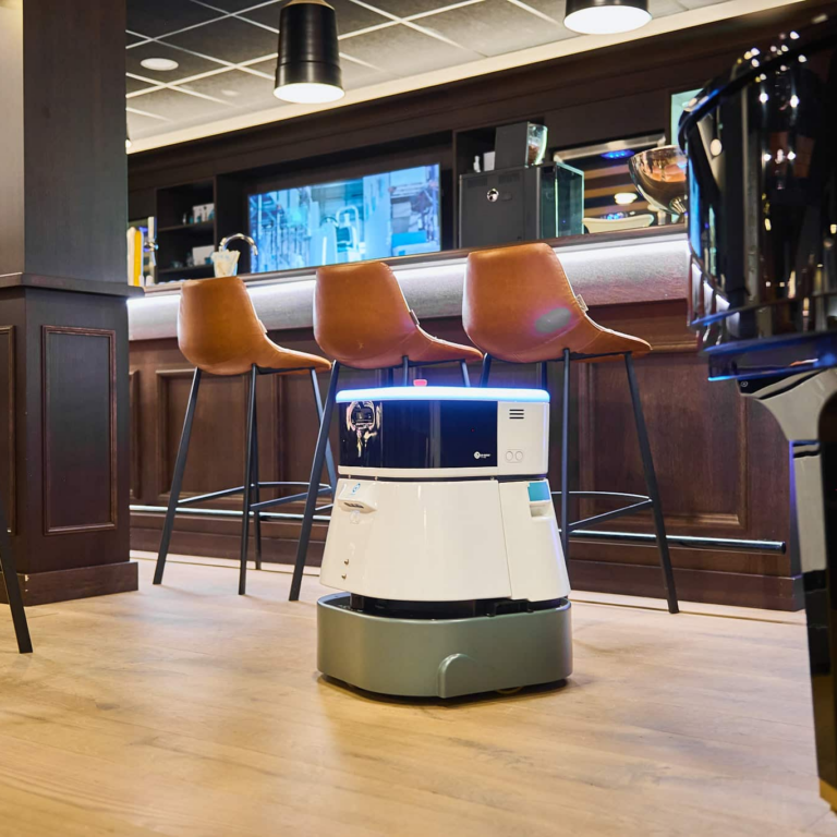i-team Co-botic 45 robotic floor cleaner beside restaurant bar seating