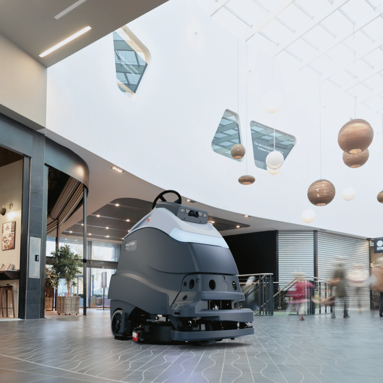 Nilfisk Liberty SC50 robotic floor scrubber cleaning a shopping centre