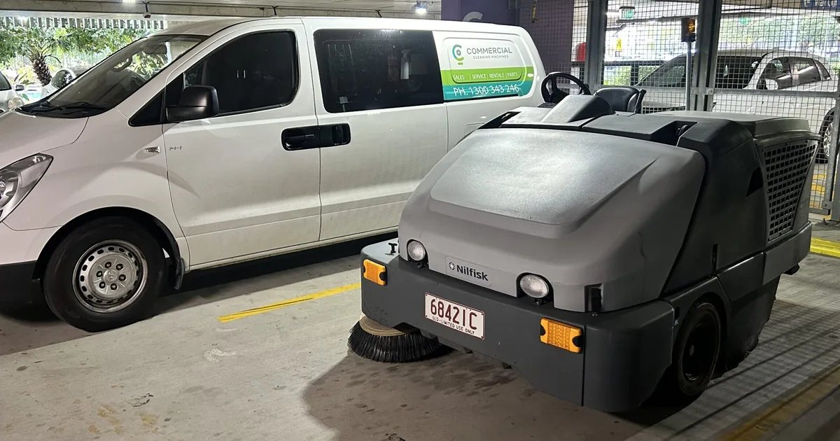 CC Machines service van and Nilfisk ride-on sweeper on a concrete carpark floor in Brisbane