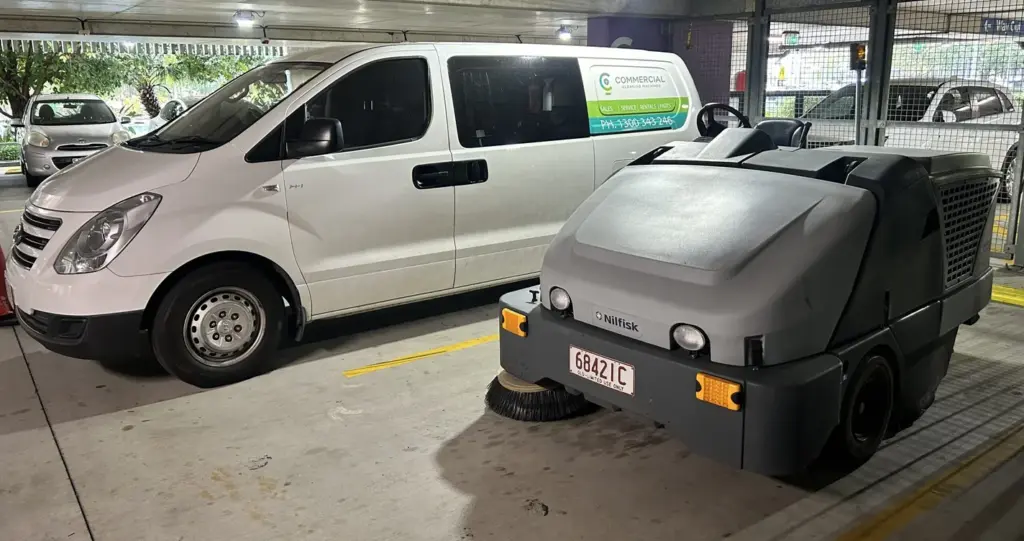 CC Machines service van beside a Nilfisk ride-on sweeper in a Brisbane car park
